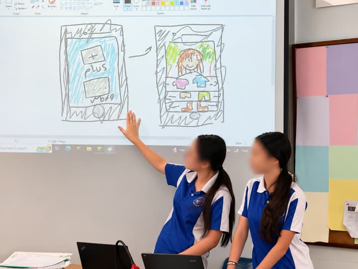Primary school students presenting a robotics project to a room