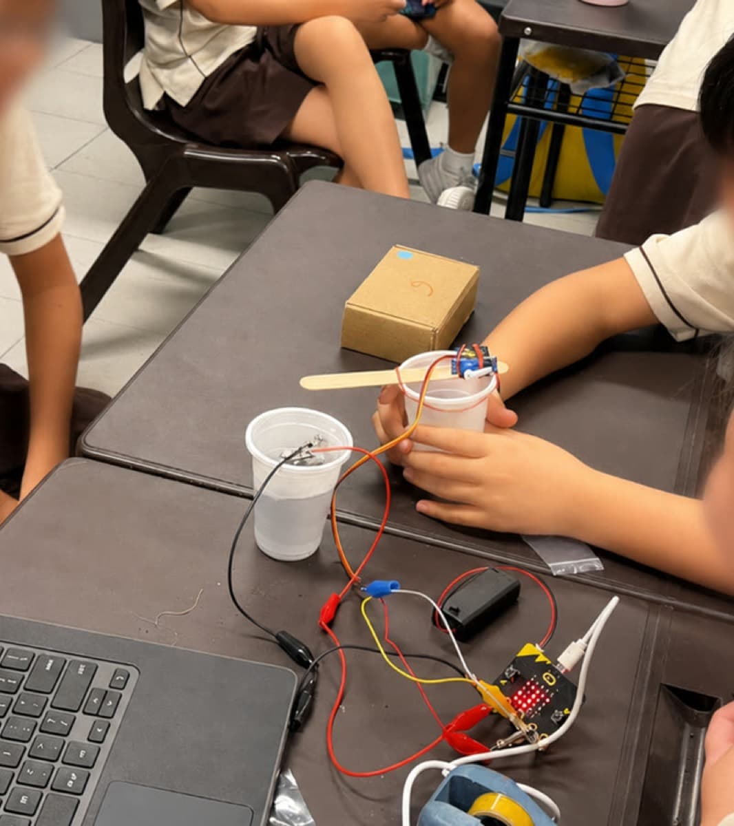 Students working on maker builds in a classroom setting